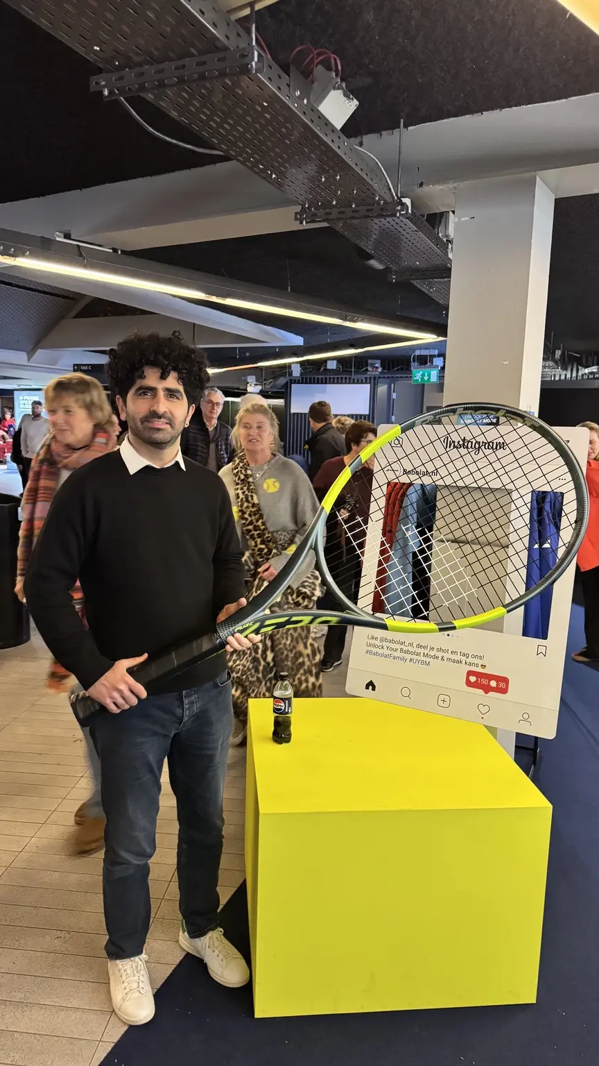 Hamidreza Amiri holding an oversized tennis racket at a tennis event